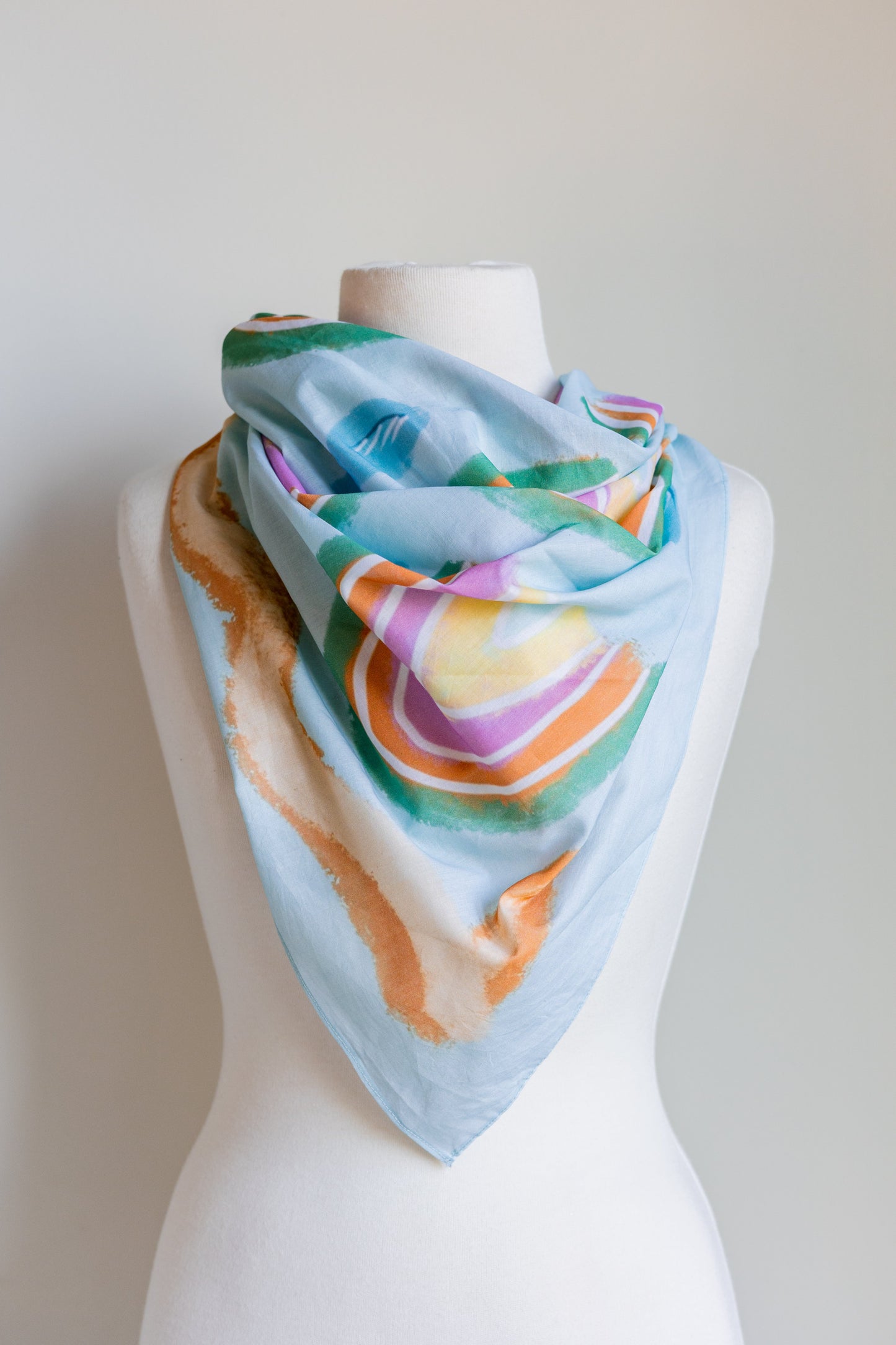 SMD original art 'Rain or Shine', light blue base with rainbows and rain, displayed as a neck scarf