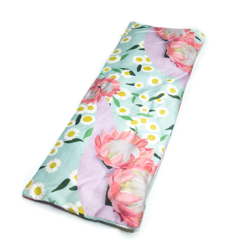 Sherrie Morgan Design relaxing eye pillow with a soft protea and daisy flower print in pink and turquoise, featured on white background