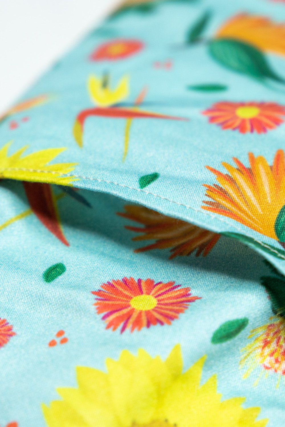 Sherrie Morgan Design Eye Pillow 'Bright and Breezy' which features sunflowers, birds of paradise and other flora. Close up of the cover opening.