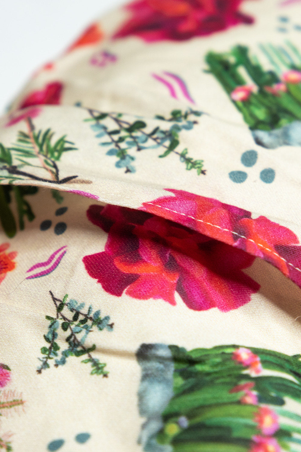 Sherrie Morgan Design relaxing wheat, heat pillow with a cactus, rose and bottlebrush flower print in pink, cover opening back of pillow