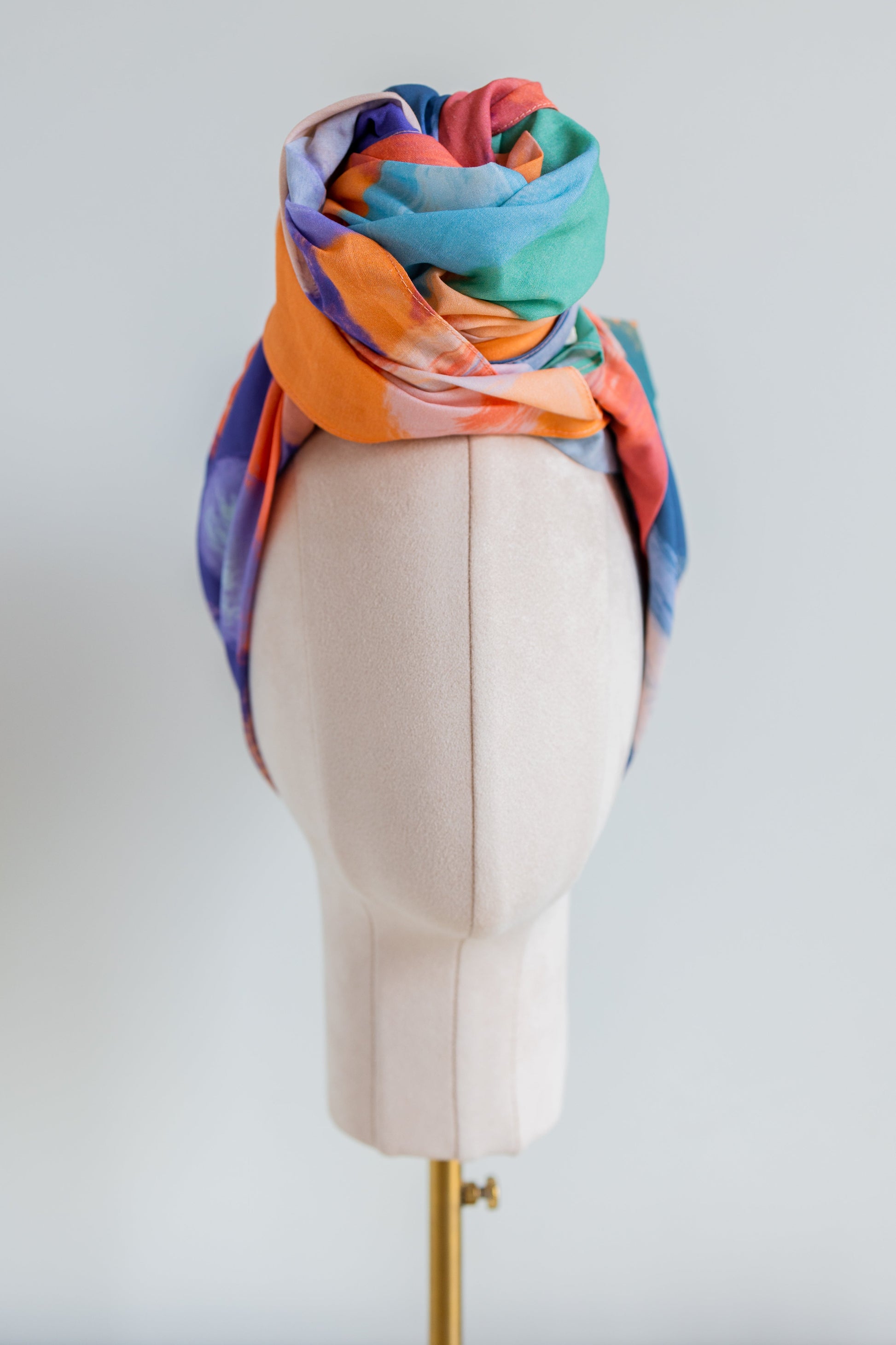 SMD original art 'Party time', vivid orange, blue and green shapes resemble party confetti, displayed as a turban with a large top knot, front view