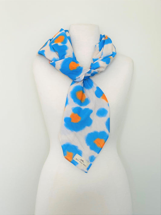 SMD original art All fired Up, blue and orange animal print  shown as a scarf.