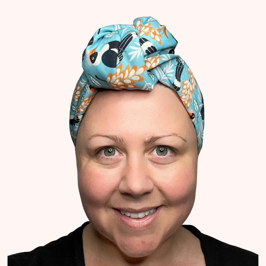 SMD scarf, toucan birds on a birght blue base, headscarf shown in a large top know, front view