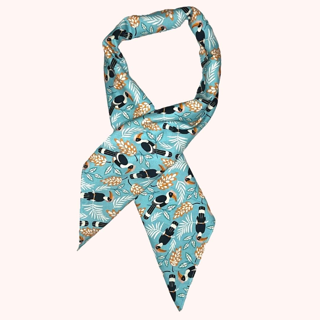 SMD scarf, toucan birds on a birght blue base, displayed as a neck scarf, print by Nerida Hansen