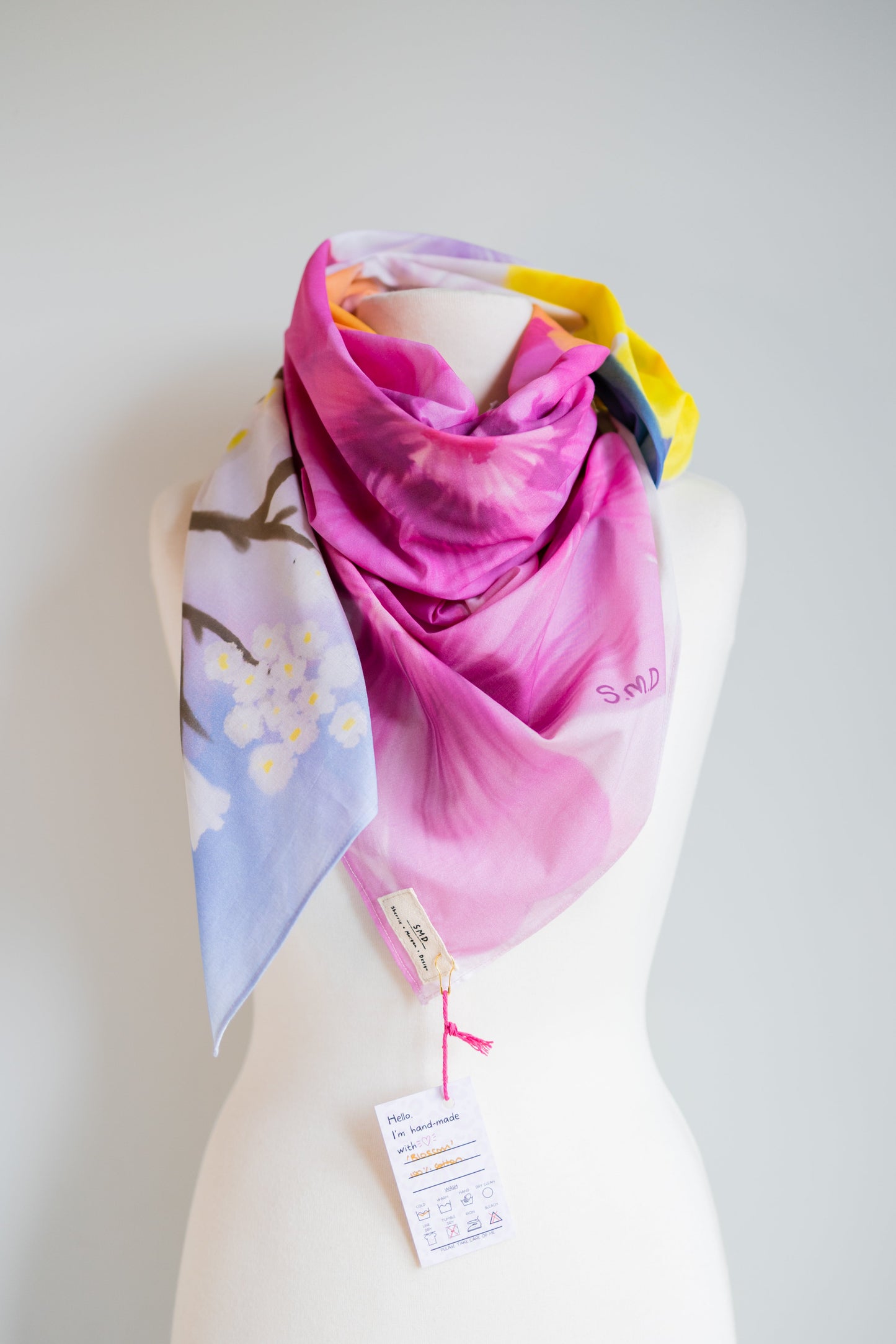 SMD Original art 'Blossom', a bright multicoloured floral design, displayed as a neck scarf front view