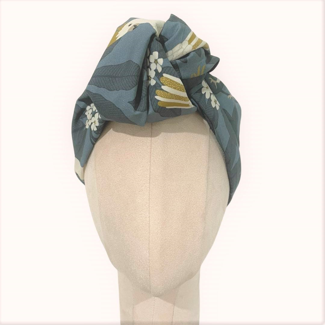 SMD scarf, Jocelyn Proust design, white galahs on a grey base, displayed as a headscarf with large knot, front view