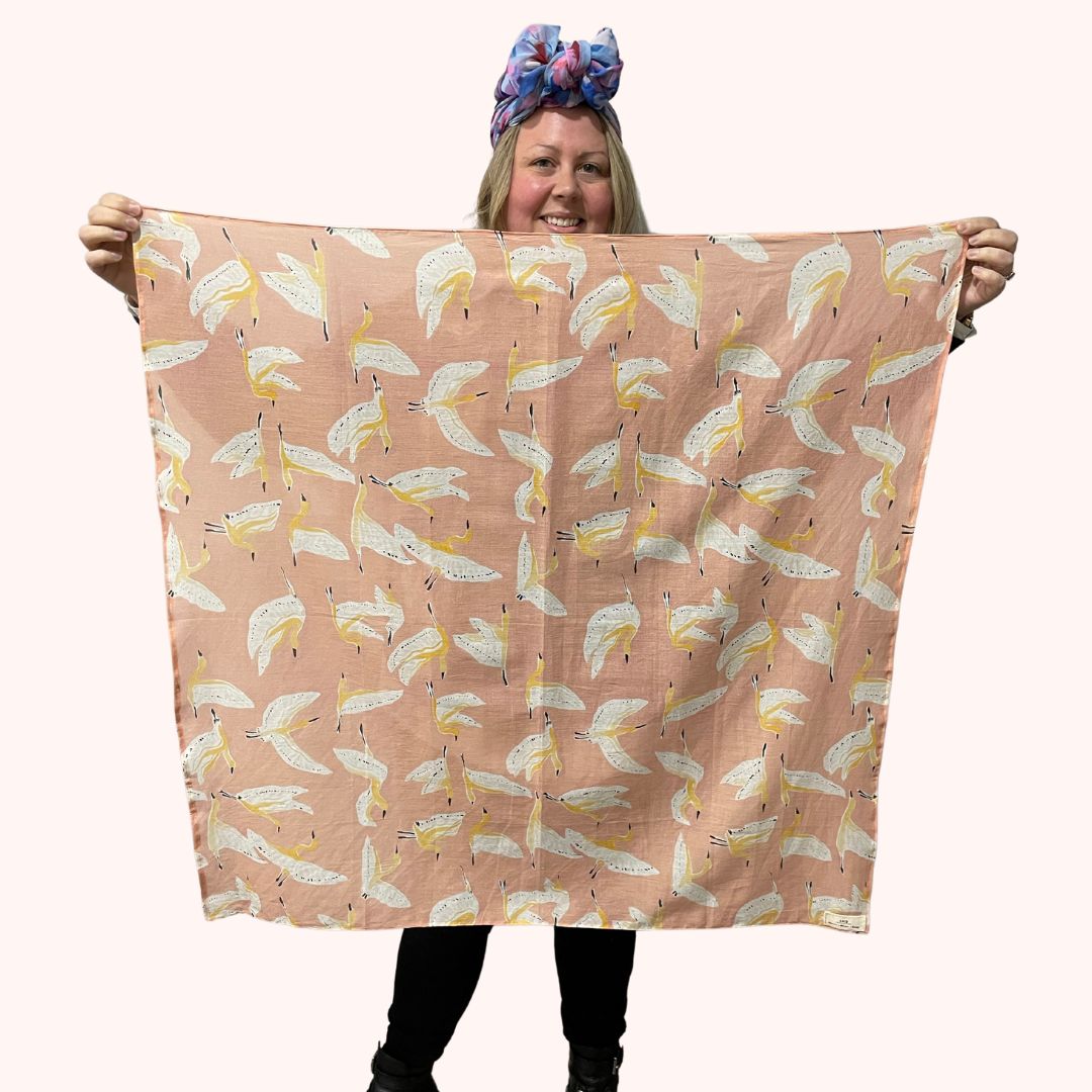 SMD scarf, peachy, birds print on apricot, full square scarf displayed.