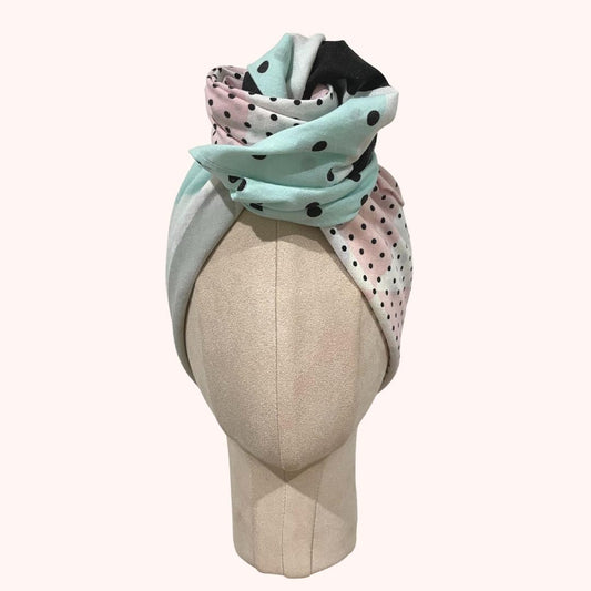 SMD upcycled scarf with pink, white, blue shapes, displayed as a headscarf with large turban knot, front view