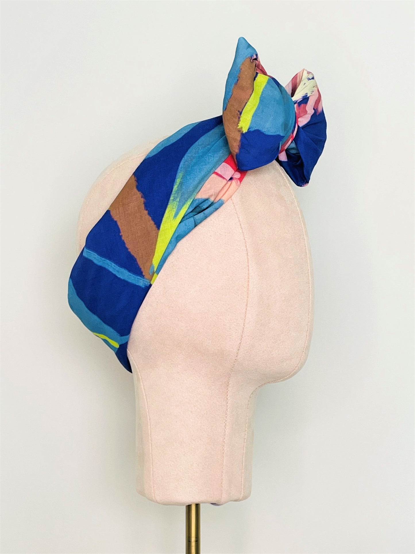 SMD original art 'Protea Multiplied', large pink king protea on a marine blue base, displayed as headscarf with a front bow, side view