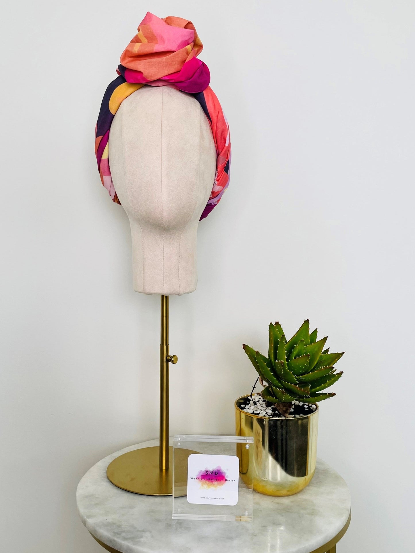 SMD original art 'Retro Floral Pink',  pink, purple and orange floral design, displayed as a head turban with large top knot, front view