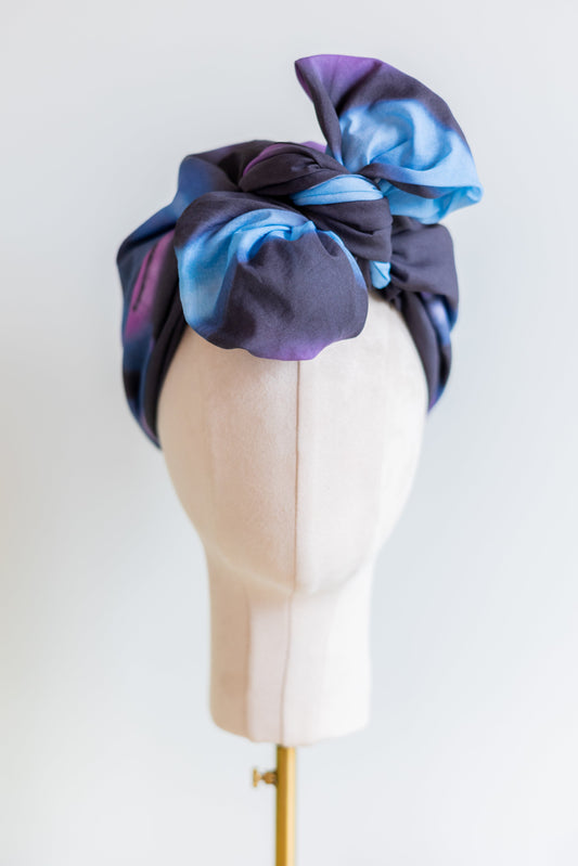 SMD original art 'Spacewalk' dark navy base with chain link, displayed as a head turban with bow, front view.