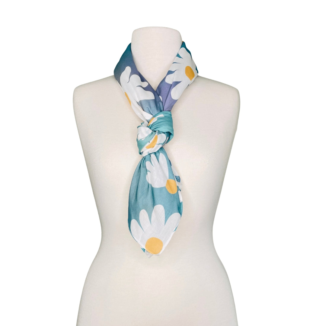 SMD orignal art, white and yellow daisies on an electric blue background, displayed as a neck scarf