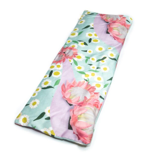 Sherrie Morgan Design relaxing eye pillow with a soft protea and daisy flower print in pink and turquoise, featured on white background