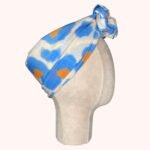 SMD original art All fired Up, blue and orange animal print  shown as a head wrap with a twisted knot, side view.