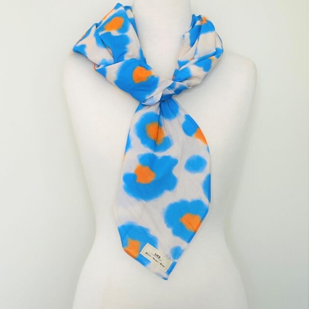 SMD original art All fired Up, blue and orange animal print  shown as a scarf.