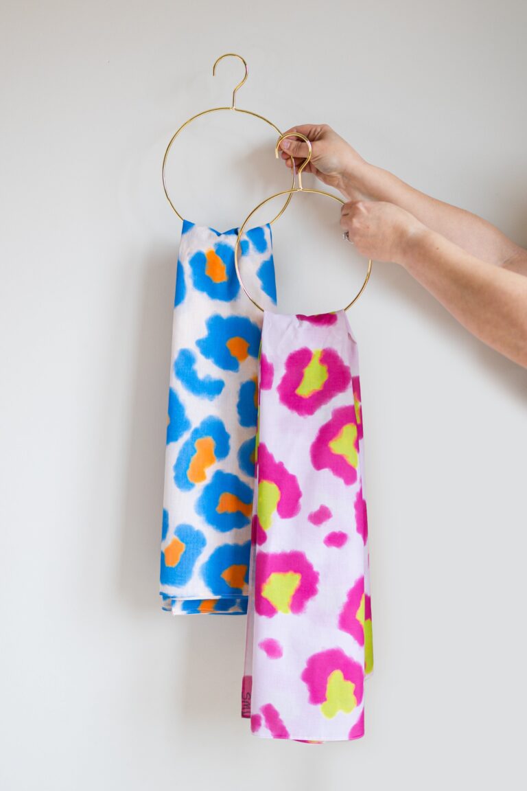 SMD original art All fired Up, blue and orange animal print  hanging on a gold hanger with Wild One - another SMD original.