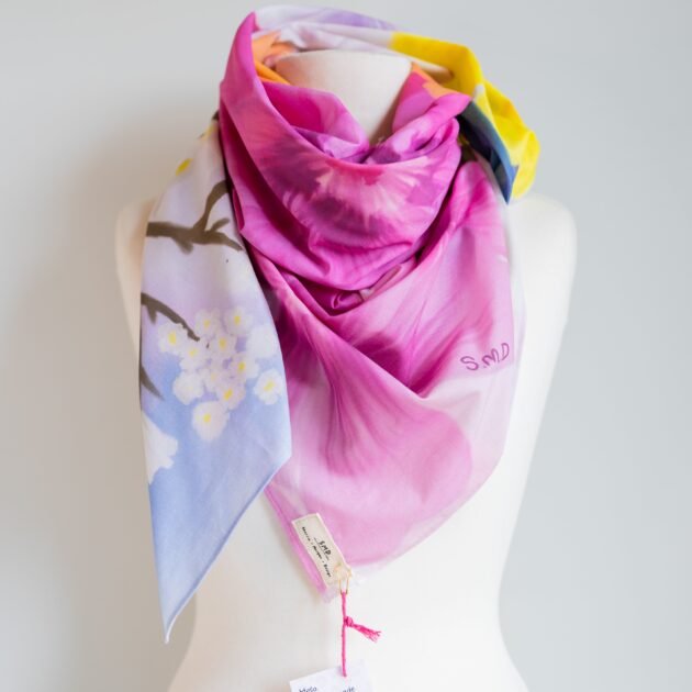 SMD Original art 'Blossom', a bright multicoloured floral design, displayed as a neck scarf front view