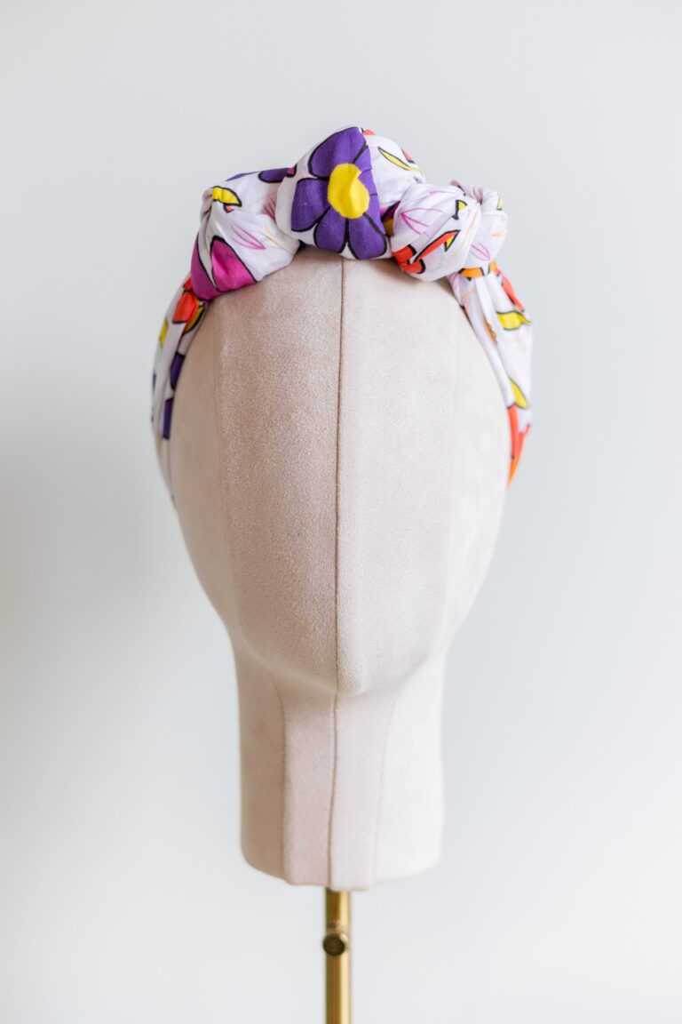 SMD Original art 'Brightside', retro floral print in pink, purple, yellow and white, displayed as a headscarf crown, front view