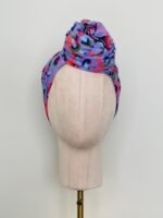 SMD scarf, coral and lilac abstract rain print, by Katie Kortman, displayed as twisted headwrap, front view