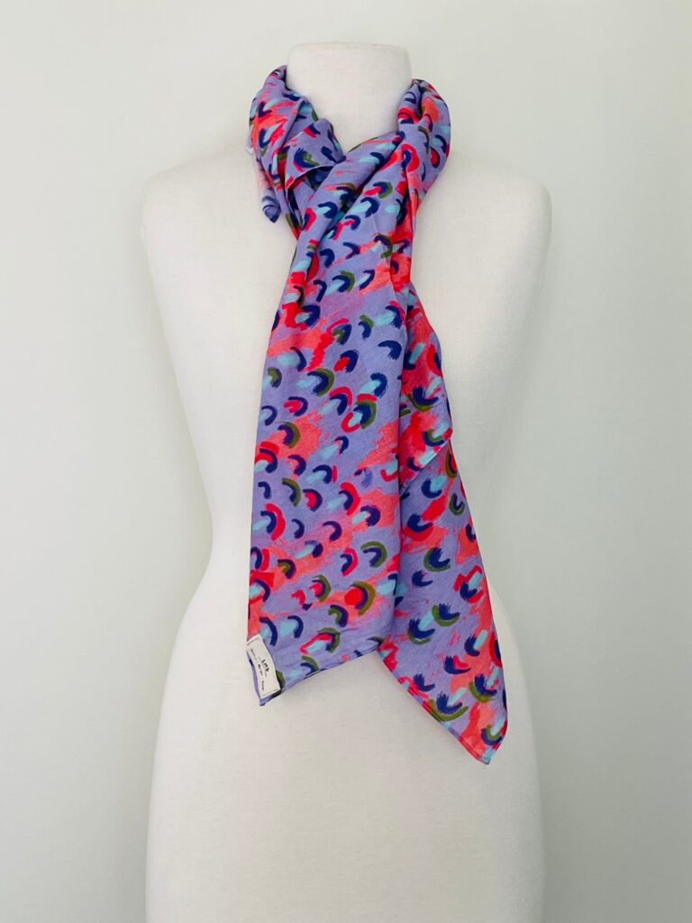 SMD scarf, coral and lilac abstract rain print, by Katie Kortman, displayed as neck scarf