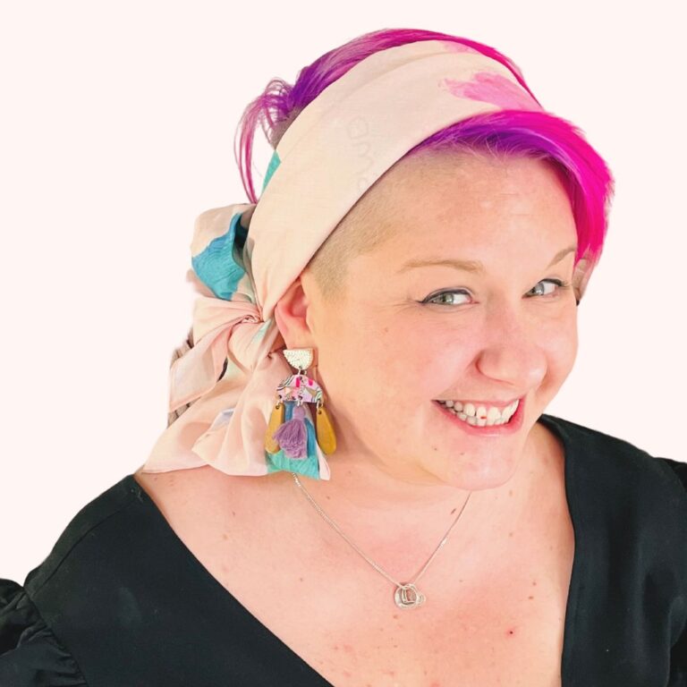 SMD original art scarf, pastel pink with green and blue shapes and abstract design, shown as headscarf with low side bow, side view