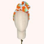 SMD original art 'Eye of the', animal print in red and green, displayed as a headwrap with a large knot, front view.