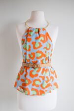 SMD original art 'Eye of the', animal print in red and green, displayed as a hankerchief style top