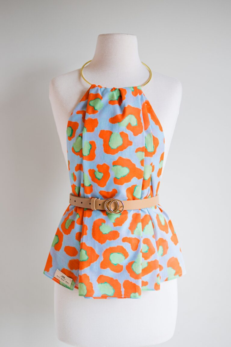 SMD original art 'Eye of the', animal print in red and green, displayed as a hankerchief style top