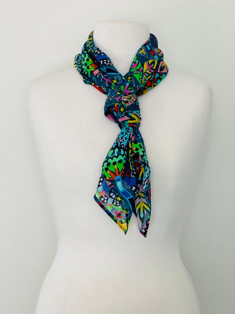 SMD scarf, Miss Moresby abstract multicoloured floral design on a dark grey base, displayed as a neck scarf
