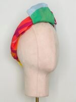 Sherrie Morgan Design original art, colourful large fruit design, yellow, orange, green, blue, red. Shown here as a knotted headscarf, Side view.