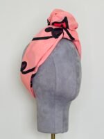 SMD original art 'Hey There', featuring a winking face with red lips on a pink base, displayed as head turban, side view
