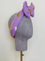 SMD, Lilac base with white, orange and brown coloured spots, headwrap with large bow, side view