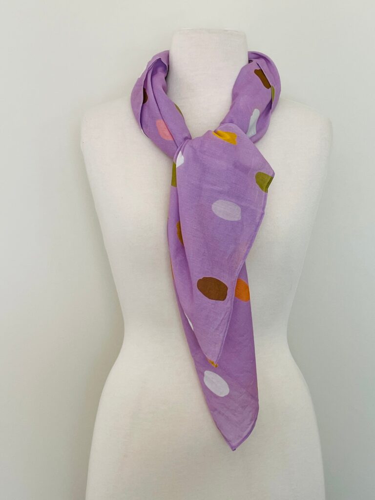 SMD, Lilac base with white, orange and brown coloured spots, displayed as neck scarf