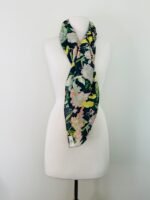 SMD scarf, navy base with a multicoloured floral sea print, shown as a neckscarf