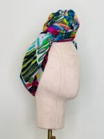 SMD scarf, Miss Moresby multicoloured design, displayed as a headscarf, side view