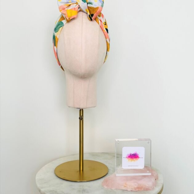 SMD, Pastel floral design, multicoloured, displayed as a headscarf in a large bow, front view, pictured with SMD plaque