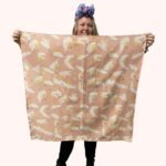 SMD scarf, peachy, birds print on apricot, full square scarf displayed.