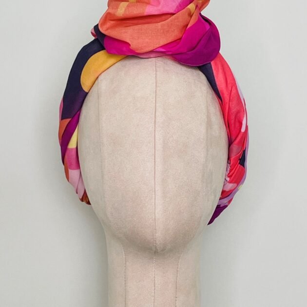 SMD original art 'Retro Floral Pink',  pink, purple and orange floral design, displayed as a head turban with large top knot, front view