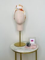 SMD scarf, upcycled fabric featuring a 70's retro floral pattern in yellow and orange, displayed as a head scarf