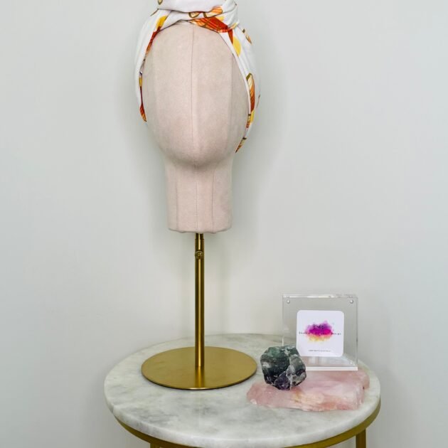 SMD scarf, upcycled fabric featuring a 70's retro floral pattern in yellow and orange, displayed as a head scarf