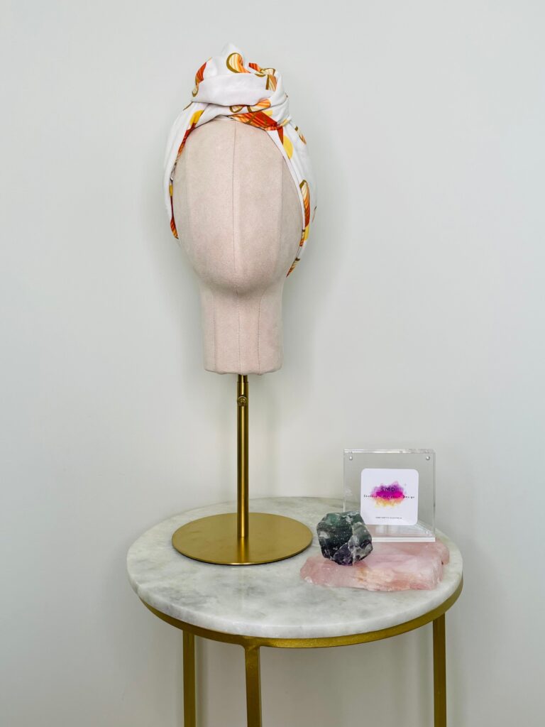 SMD scarf, upcycled fabric featuring a 70's retro floral pattern in yellow and orange, displayed as a head scarf