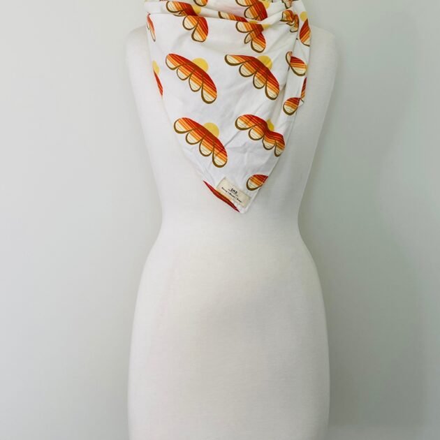 SMD scarf, upcycled fabric featuring a 70's retro floral pattern in yellow and orange, displayed as a neck scarf
