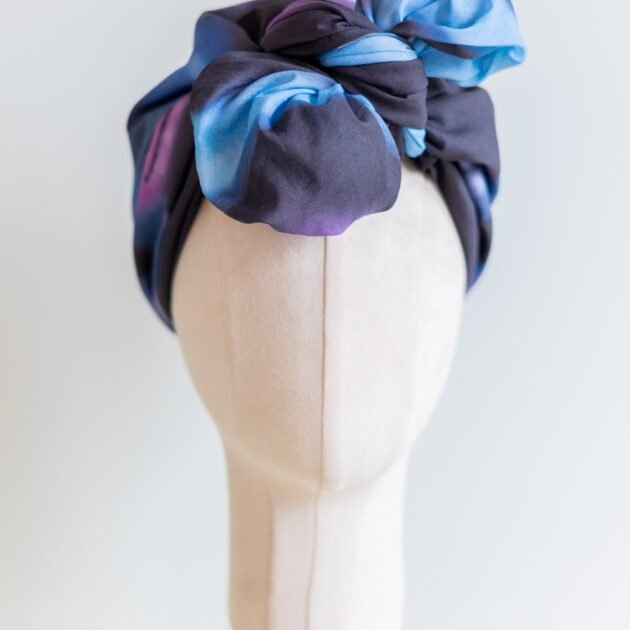 SMD original art 'Spacewalk' dark navy base with chain link, displayed as a head turban with bow, front view.