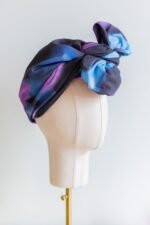 SMD original art 'Spacewalk' dark navy base with chain link, displayed as a head turban with bow, side view.