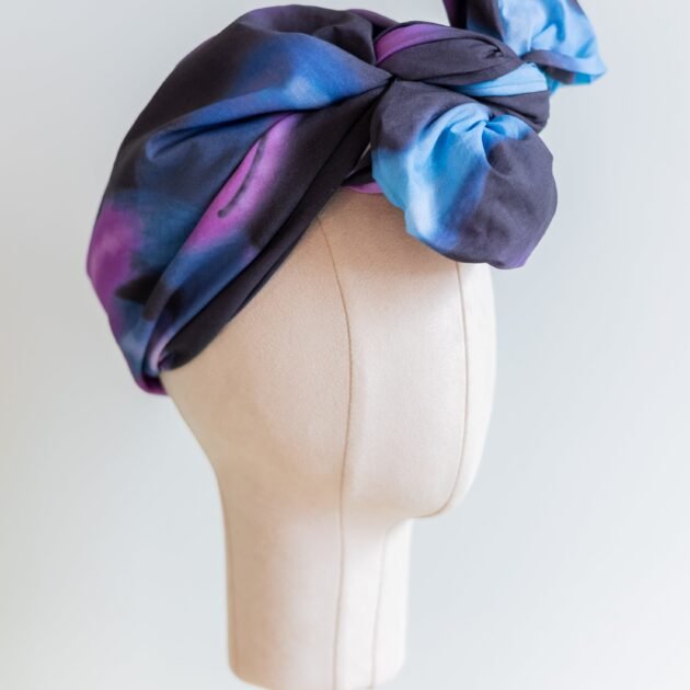 SMD original art 'Spacewalk' dark navy base with chain link, displayed as a head turban with bow, side view.
