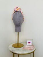 SMD scarf, white base with ladies and dogs walking in pink and yellow, knotted headscarf, front view